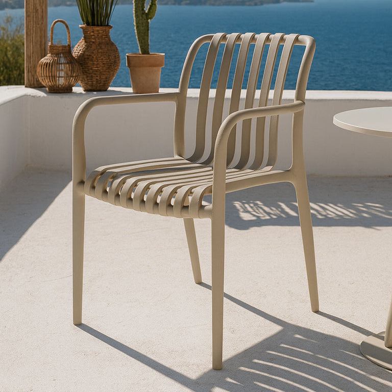 Silla de jardín Greta color beige en terraza con vistas al mar y diseño de lamas verticales