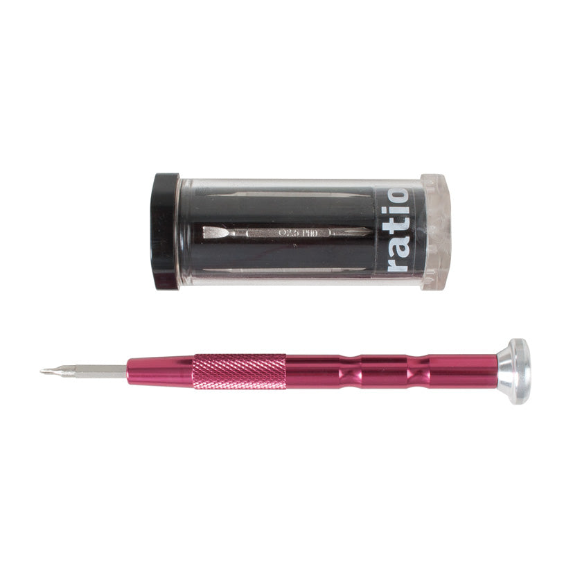Destornillador de precisión con mango de aluminio anodizado rosa y estuche de almacenamiento cilíndrico.