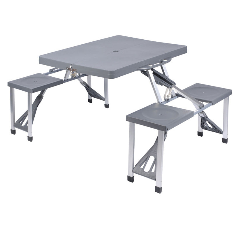 Mesa de picnic plegable color gris con cuatro asientos integrados y estructura de aluminio para exterior.