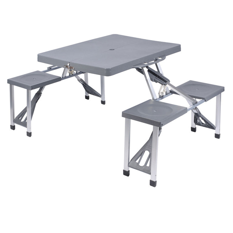 Mesa de picnic plegable color gris con cuatro asientos integrados y estructura de aluminio para exterior.