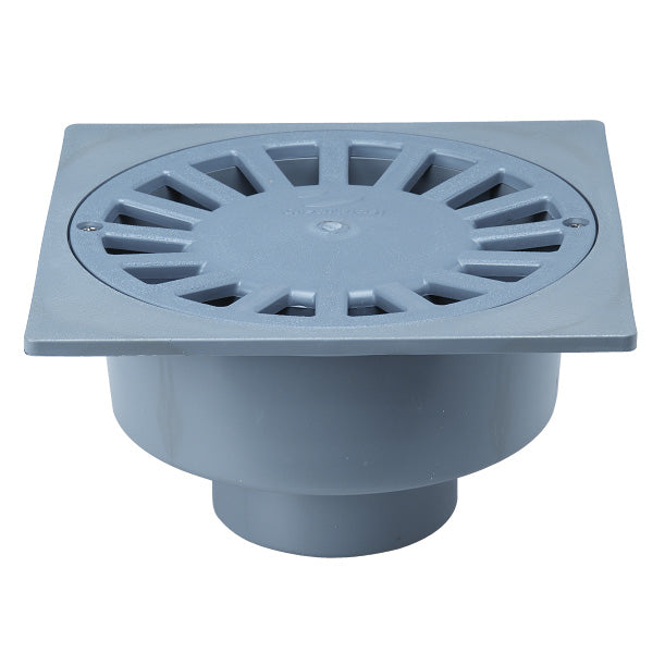 Sumidero sifónico de PVC gris con rejilla circular ranurada y salida vertical para evacuación de aguas.