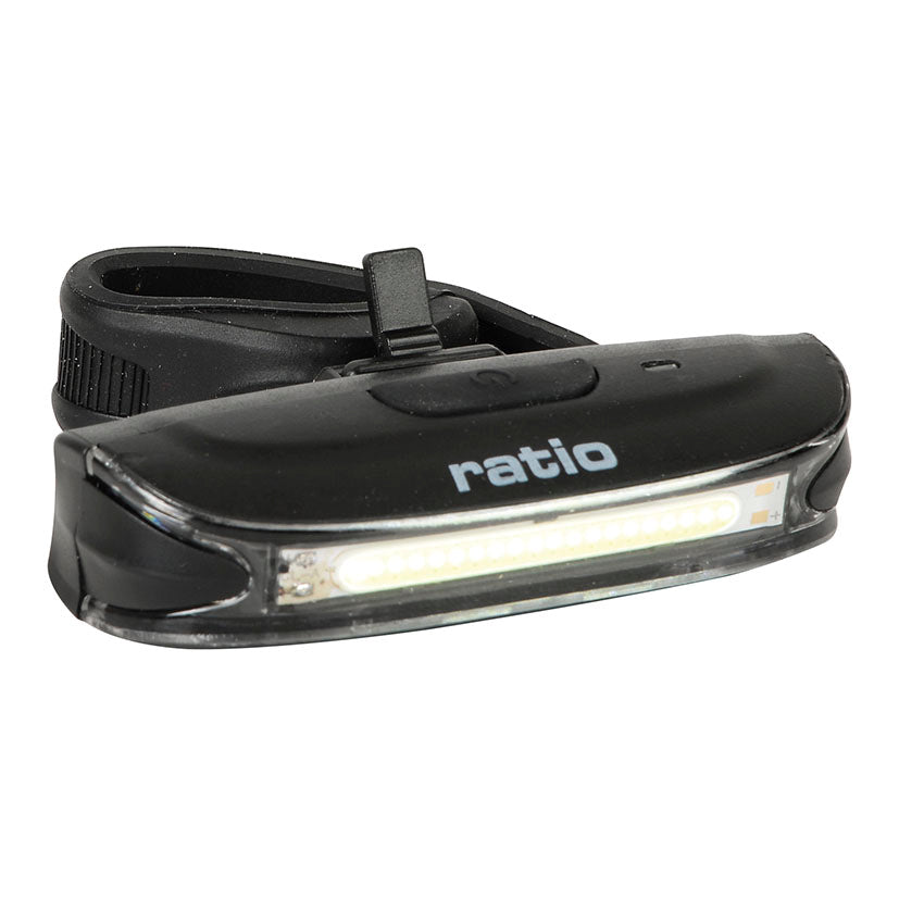 Luz frontal LED COB RATIO BikeLight 5577HD negra con soporte de goma y botón de encendido superior.