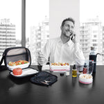 Hombre en oficina utilizando el set de condimentos IRIS para aliñar su comida para llevar.