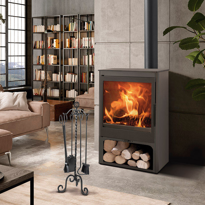 Accesorios de chimenea modelo Gaudí situados junto a una estufa de leña moderna en un salón contemporáneo.