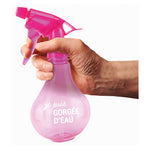 Primer plano de mano sujetando pulverizador rosa de 330ml mostrando el gatillo ergonómico y cómodo.