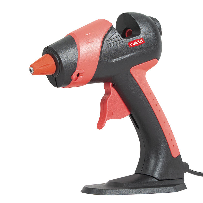 Pistola termoencoladora RATIO R-P25 de 25W en color negro y rojo con soporte de base estable.