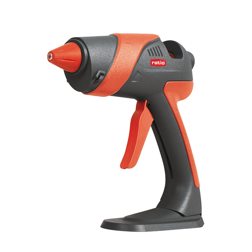 Pistola termoencoladora RATIO R-P70 de 70W en color naranja y gris con base de apoyo integrada.