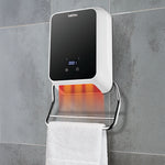 Calefactor toallero HABITEX instalado en pared de baño emitiendo calor sobre toalla