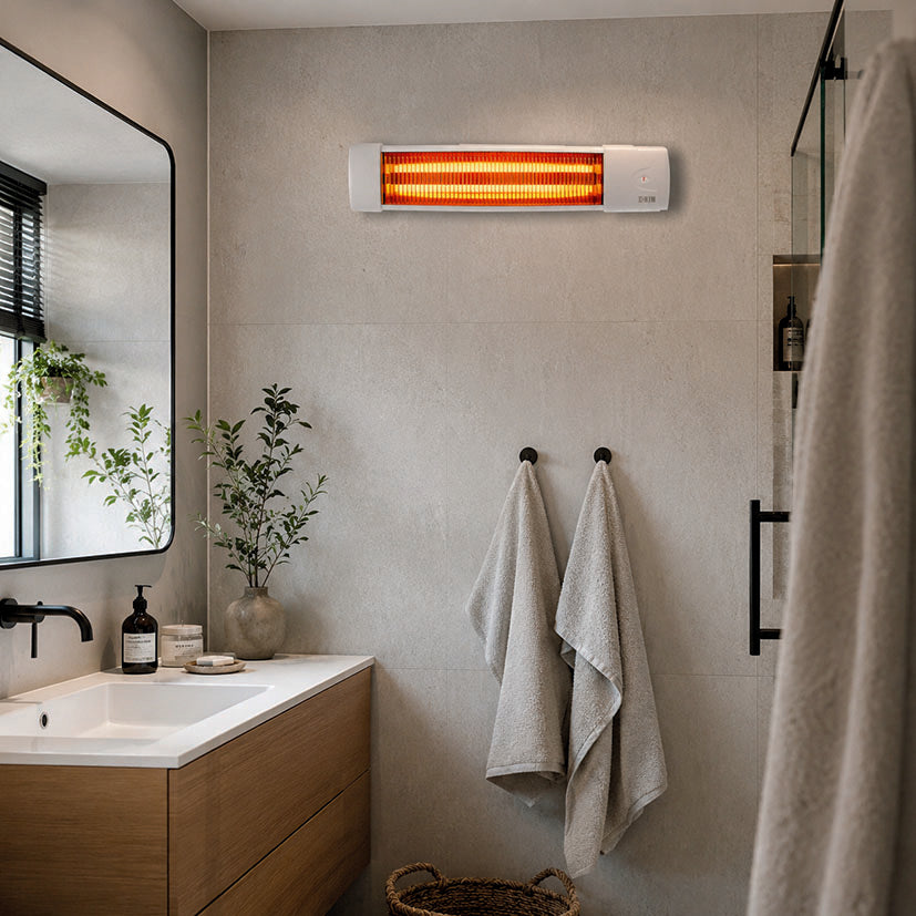 Radiador halógeno HJM 510 instalado en la pared de un baño moderno sobre el toallero.